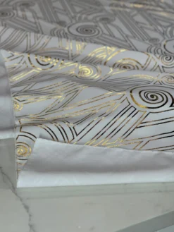 Luxor (Metallic Print) Table Linen in White and Gold
